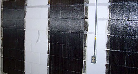 Carbon fiber mesh strips applied to a concrete block foundation wall