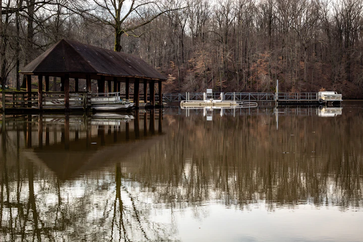 Covered boat dock on a calm lake
